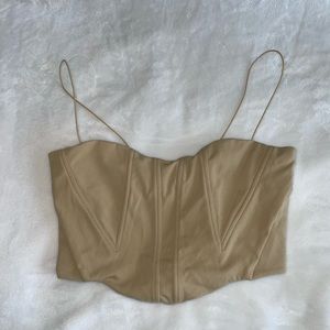 Tan corset-like top with thin elastic straps. Size Large
